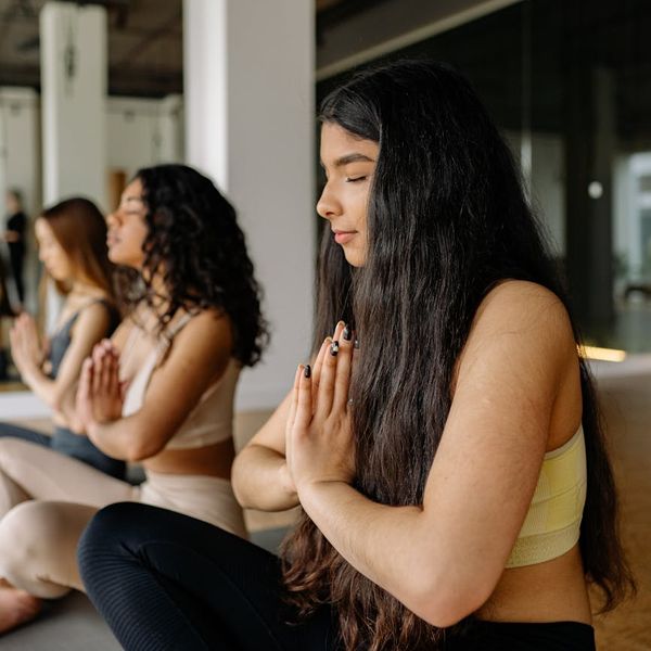 Close up of hands in a yoga mudra position.